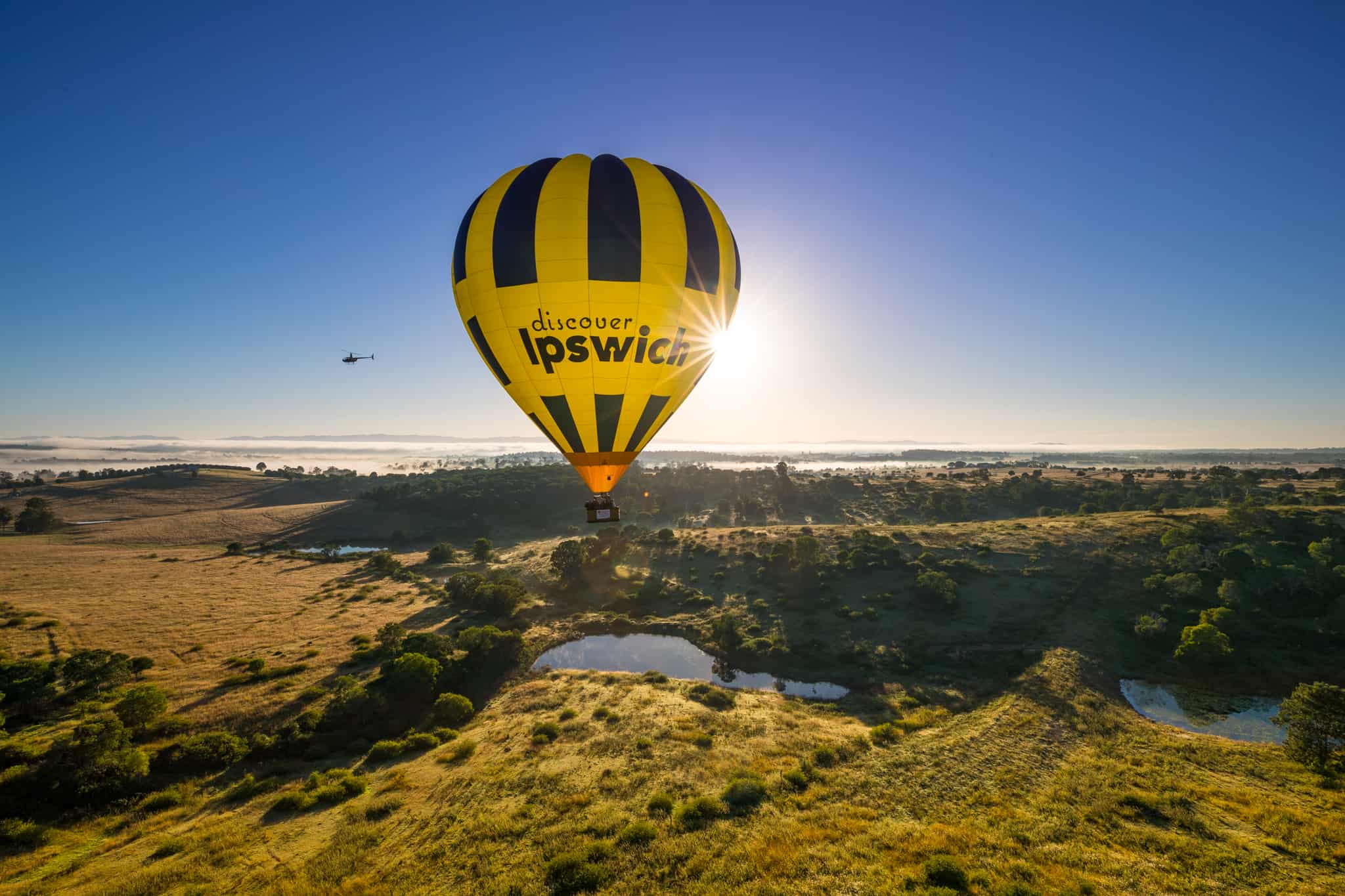 Hot air balloon flying over countryside