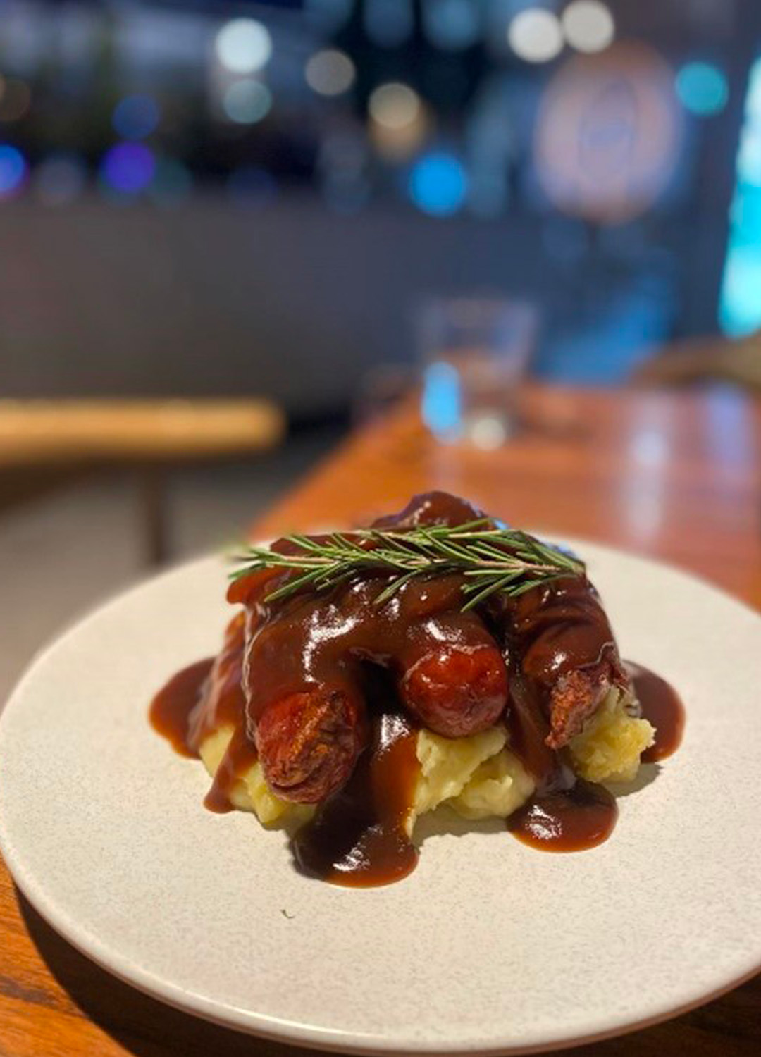 Sausages and gravy on mashed potato at Club Parkview