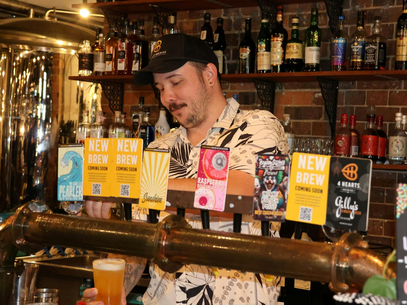 Man pulling a beer behind the bar